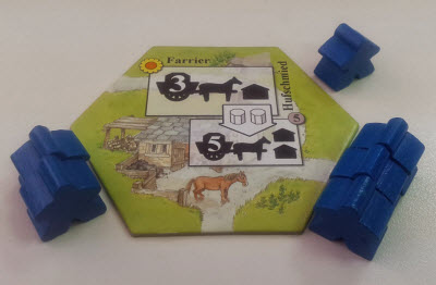 Here, players bid for the Farrier. The first player used Blue workers, so only Blue may be used. Another player is currently winning the bid with three.